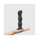 Strap-on-me Geisha Ball Dildo XL Black held in hand, showcasing its sleek design and versatile use.
