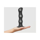Strap-on-me Geisha Ball Dildo XL Black held in hand, showcasing its sleek design and three internal balls.