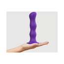 Strap-On-Me Geisha Ball Dildo XL Purple held in hand, showcasing its liquid silicone design for smooth penetration.