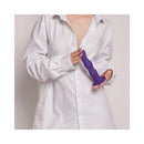 Person holding the Strap-On-Me Geisha Ball Dildo XL Purple, showcasing its sleek design and liquid silicone texture.