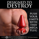 Master Series Anal Destructor Small Butt Plug Red being held, perfect for pushing limits in anal play.