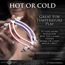 Master Series Stainless Steel Adjustable Pussy Clamp Grey for temperature play demonstration in hand.