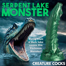 Cockness Monster Lake Creature Silicone Dildo next to a serpent lake monster in a dark lake setting.