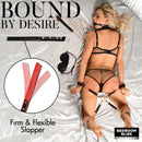 Bedroom Bliss Lover's Deluxe Bondage Set Black featuring a flexible slapper, black cuffs, and blindfold on satin bed.