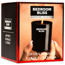 Bedroom Bliss Lover's Massage Candle Vanilla in a sleek black container with a soft burning flame.