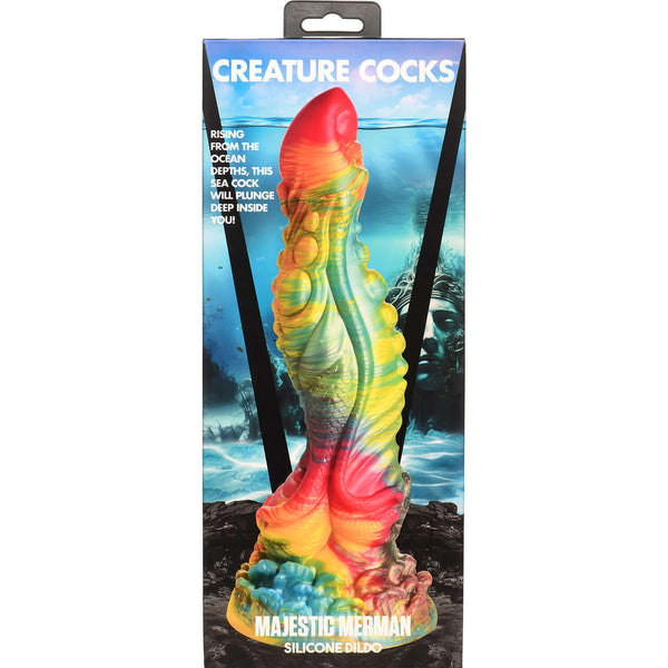 Creature Cocks Majestic Merman 10” Dildo in packaging with iridescent rainbow color pattern and oceanic background.