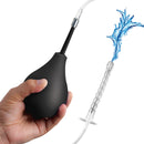 CleanStream Enema Bulb Kit with 3 Attachments Black being held, ready for use with tubing and water spray.
