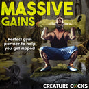 A man lifts the Creature Cocks Scaly Swamp Monster 3 Foot Giant Dildo, showcasing massive gains in the gym.