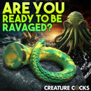 Creature Cocks Titan Tentacle Extra Long Silicone Dildo displayed on rocky surface with ocean background.