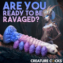 Tenta-Queen Ovipositor Silicone Dildo with Eggs on display with a fantasy-themed background.