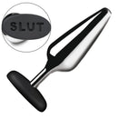 Master Series Butt Slut Metal & Silicone Butt Plug showcasing aluminum alloy with silicone base spelling SLUT.