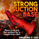 Creature Cocks Demon Claw Fisting Silicone Dildo Red with strong suction base for hands-free use against a dramatic background.