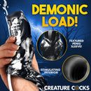 Night Prowler Squirting Silicone Penis Enhancer Silver with textured design and squirt feature held in hand.
