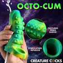 Tentacle Squirting Silicone Penis Enhancer Green in hand, showcasing textured sleeve and stimulating interior.