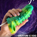 Tentacle Squirting Silicone Penis Enhancer Green held in hand with squirt feature and textured design.