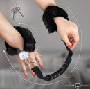 Master Series the Handler Furry Handcuffs with Handle on wrists with plush faux fur for comfort and style.