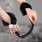 Master Series the Handler Furry Handcuffs with Handle on wrists with plush faux fur for comfort and style.