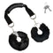 Master Series the Handler Furry Handcuffs with Handle featuring plush faux fur and a comfortable grip handle.