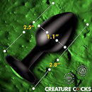 Creature Cocks Green Eye Silicone Butt Plug Small dimensions with vivid green cat-eye detail on a textured background.