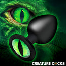Creature Eye Green Eye Silicone Butt Plug Large with a vivid green cat-eye design against a fantasy background.