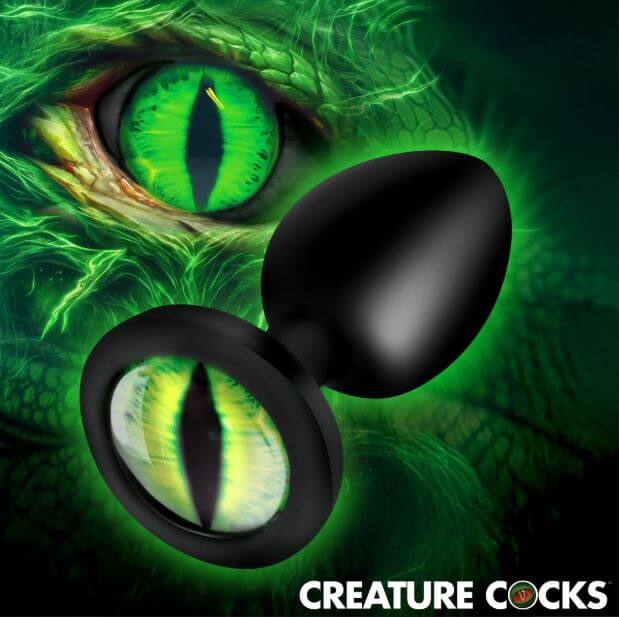 Creature Cocks Green Eye Silicone Butt Plug Small against a vibrant green eye background.