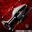 Creature Cocks Red Eye Metal Butt Plug Medium displayed on a striking red background with measurement highlights.
