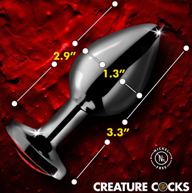 Creature Cocks Red Eye Metal Butt Plug Medium displayed on a striking red background with measurement highlights.