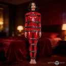 Master Series Backbone Full Body Harness showcasing a model in a red latex suit and restraint system in an intimate setting.