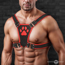 Master Series Alpha Pup Bulldog Harness Red worn by a muscular man showcasing its bold design and paw print.