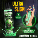 Creature Cum Green Jizz Lubricant 4 Oz bottle with vibrant green formula dripping from fingers, showcasing water-based lube.