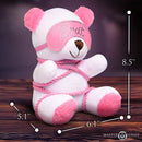 Master Series Brat Bondage Bear Plush Toy with pink rope and blindfold on a wooden table.