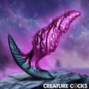 Creature Cocks Octo-Twist Silicone Anal Plug Purple showcasing fantasy-inspired texture and design on a cosmic background.