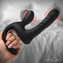 Master Series Thrust Pounder Thrusting Silicone Vibrator held in hand, showcasing its vibrating and thrusting features.