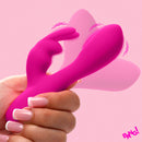 Bang Flexible Silicone Mini Rabbit Vibrator Pink held in hand with a pink background.