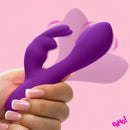 Flexible Vibrating Silicone Mini Rabbit Purple held in hand on a pink background, showcasing its unique dual-motor design.