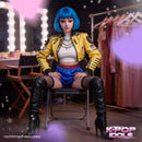 K-Pop Idol Dreamgirl Realistic Love Doll with blue hair in stylish outfit, seated in a dressing room setting.