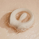 ZALO Apis Vibrating Couples Ring Ivory White floating in water with a sleek design and smooth texture.