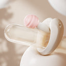 ZALO Apis Vibrating Couples Ring Obsidian Black displayed on a glass object with a pink accent.