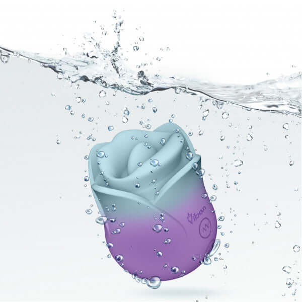Succubus Vibrating Kissing Rose by Viben submerged in water with splashes, showcasing its elegant design.