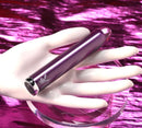 Playboy Amethyst Vibrator - 10 speeds, glass tip, waterproof, rechargeable device against white mannequin hand on pink background