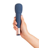 Deia the Wand Massager with Recharging Base Navy held in hand, showcasing its elegant design and functionality.