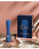 Deia the Wand Massager with Recharging Base Navy displayed alongside its elegant packaging on a satin background.