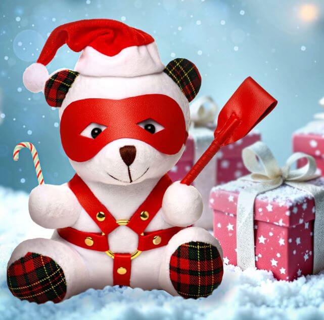 MS Holiday Bear White in Santa hat with kinky accessories, posing with candy cane and shovel among festive gifts.