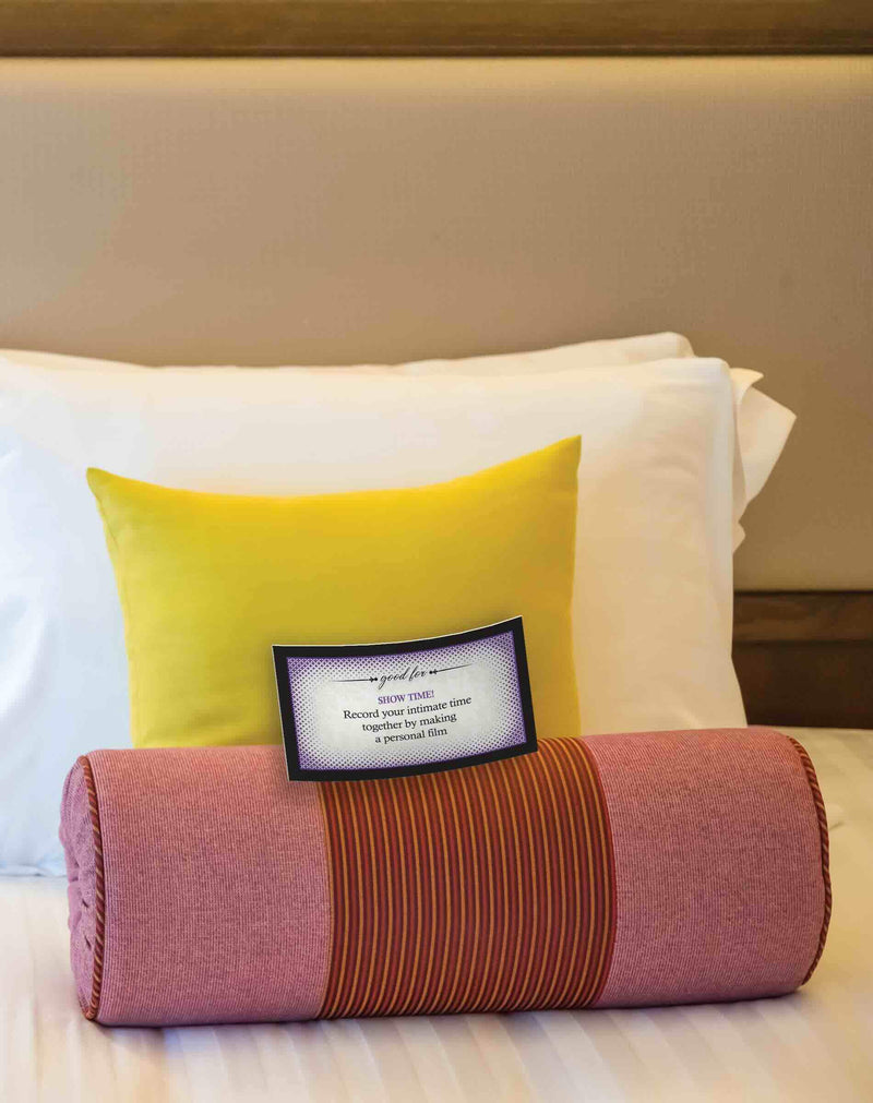 Decorative pillows on bed with a framed inspirational quote.