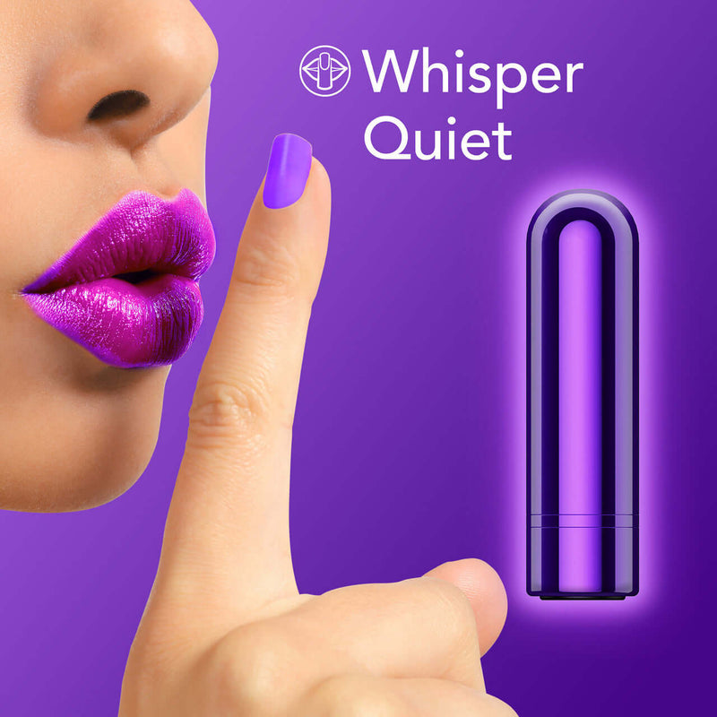 Whisper quiet grape Kool Vibes Rechargeable Mini Bullet Vibrator near lips and finger hushing.