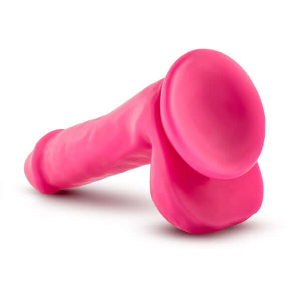 Neo 6-Inch Dual Density Dildo with Balls in Neon Pink by Blush Novelties, featuring realistic sculpting and Sensa Feel technology for comfort and rigidity.
