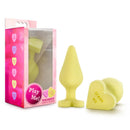 Naughty Candy Heart Spank Me Butt Plug Yellow in packaging alongside the plug, highlighting its playful design.