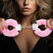 Woman holding pink Temptasia Beginner Cuffs with faux fur lining and adjustable design.