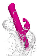 Commotion Samba Raspberry Pink Rabbit Vibrator splashing in water with dynamic motion and powerful vibration.