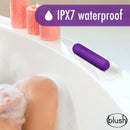 Play With Me Cutey Vibe Plus Bullet Purple Vibrator positioned by candles on the edge of a bathtub, showcasing its waterproof feature.